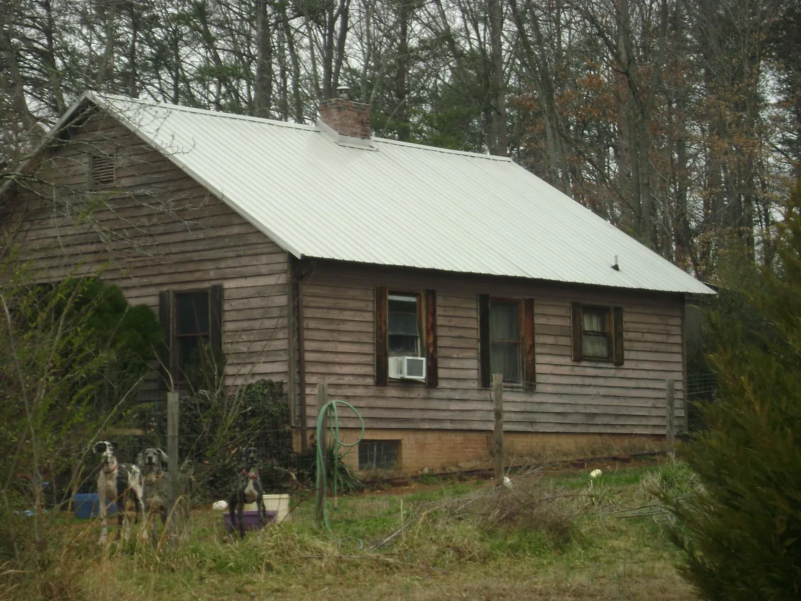 White metal roof on an old wood sided farmhouse, from a Metal Roof Installation job in East Andover